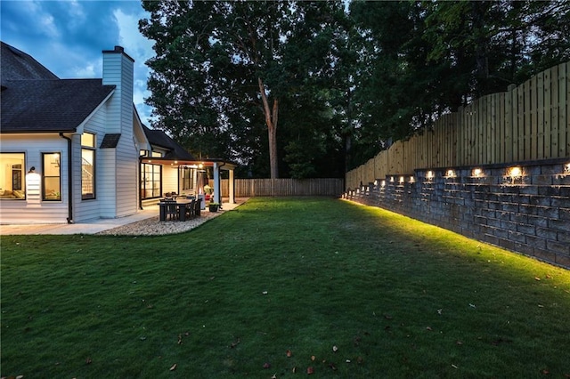 view of yard featuring a fire pit and a patio