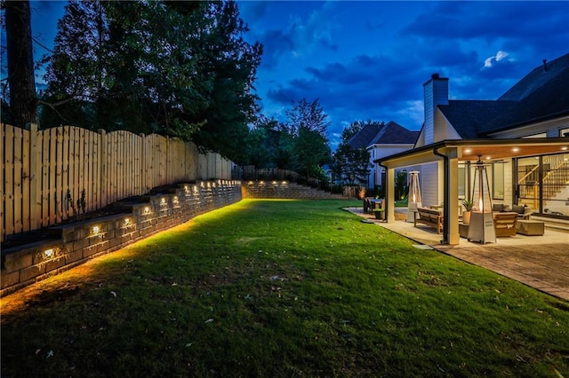 yard at dusk with a patio and an outdoor hangout area