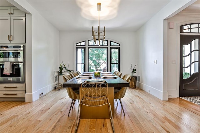 dining space featuring a chandelier and light wood-type flooring