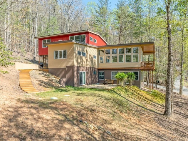 back of house with a deck