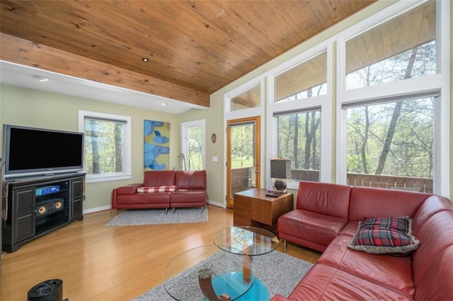 living area featuring wood finished floors, vaulted ceiling, baseboards, and wood ceiling