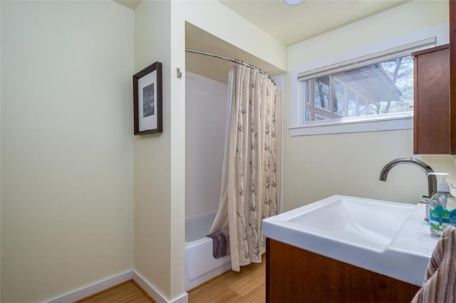 bathroom featuring vanity, shower / bath combo with shower curtain, and wood finished floors