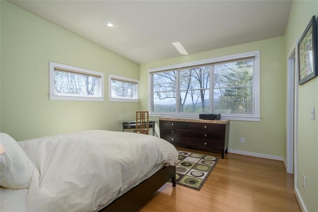 bedroom featuring baseboards and wood finished floors