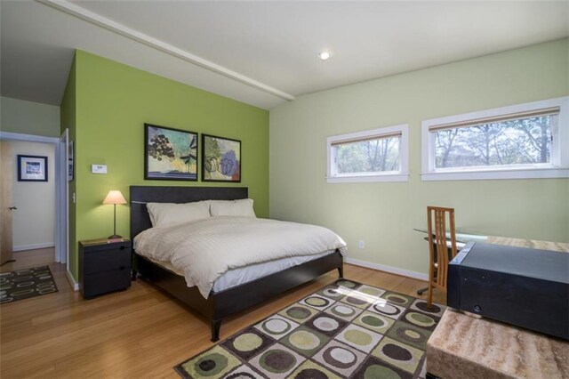 bedroom with wood finished floors and baseboards
