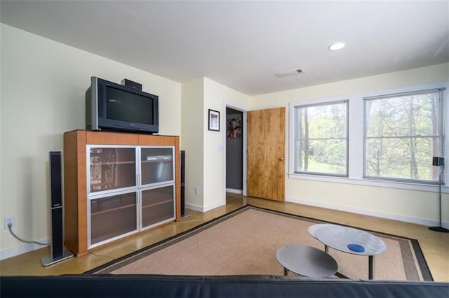 unfurnished living room with visible vents, baseboards, and recessed lighting