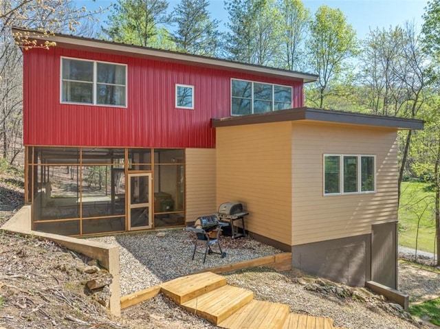 rear view of house with a sunroom