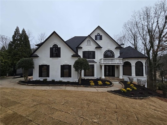 7910 Tintern Trce, Duluth, GA 30097 - french country style house featuring roof with shingles, stucco siding, and a balcony