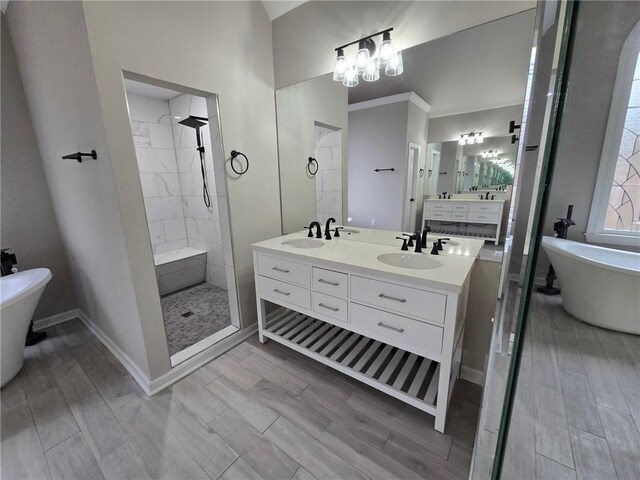 7910 Tintern Trce, Duluth, GA 30097 - full bathroom with double vanity, baseboards, tiled shower, a soaking tub, and a sink