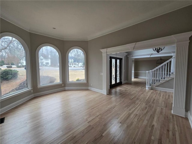 7910 Tintern Trce, Duluth, GA 30097 - interior space featuring crown molding, stairs, decorative columns, wood finished floors, and baseboards
