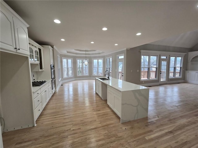 7910 Tintern Trce, Duluth, GA 30097 - kitchen with open floor plan, gas cooktop, a sink, and light wood-style floors