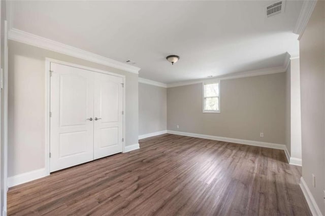 5737 Russell Ct, Douglasville, GA 30135 - unfurnished bedroom featuring visible vents, baseboards, ornamental molding, and wood finished floors
