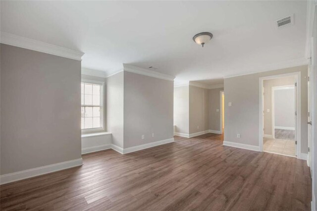 5737 Russell Ct, Douglasville, GA 30135 - spare room with wood finished floors, baseboards, ornamental molding, and visible vents