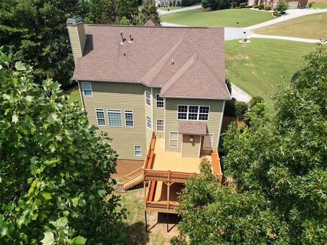 5737 Russell Ct, Douglasville, GA 30135 - rear view of house featuring roof with shingles, a chimney, a wooden deck, and a yard