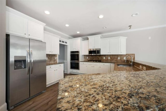 5737 Russell Ct, Douglasville, GA 30135 - kitchen with a sink, appliances with stainless steel finishes, dark stone countertops, and crown molding