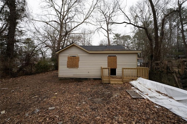 back of house with a deck