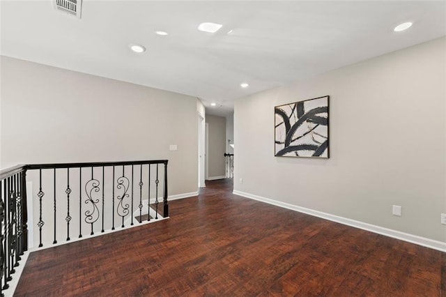 spare room featuring recessed lighting, visible vents, baseboards, and wood finished floors