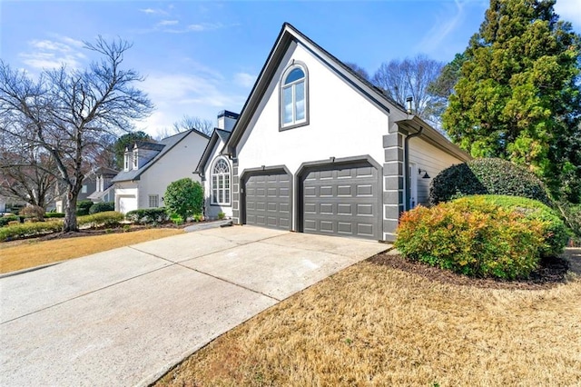 view of property exterior with driveway and stucco siding