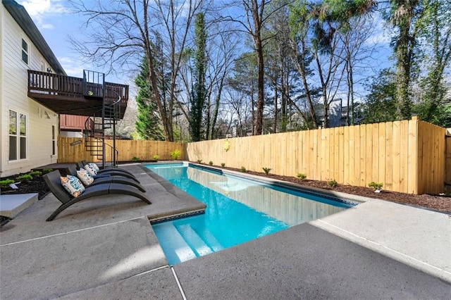 view of pool featuring a deck, a patio, a fenced backyard, a fenced in pool, and stairs