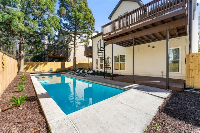 view of pool with a patio, a fenced in pool, a fenced backyard, stairs, and a deck