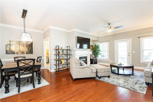 211 Colonial Homes Dr NW Unit 2501, Atlanta, GA 30309 - living area with dark wood-type flooring, a glass covered fireplace, ornamental molding, ceiling fan, and baseboards
