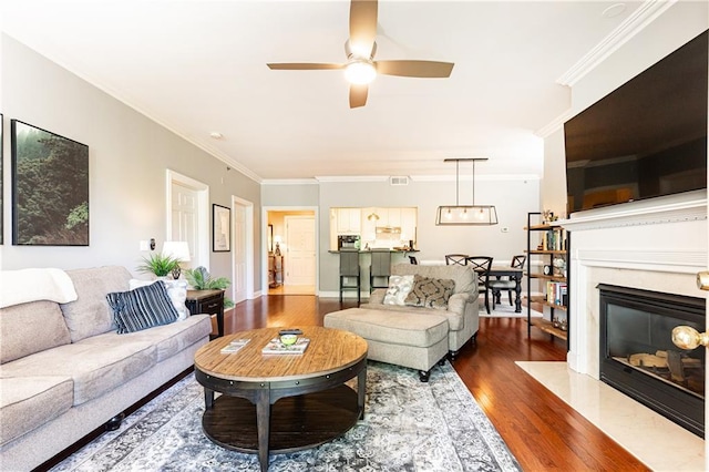 211 Colonial Homes Dr NW Unit 2501, Atlanta, GA 30309 - living area with wood finished floors, ornamental molding, a ceiling fan, and a fireplace