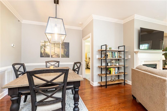 211 Colonial Homes Dr NW Unit 2501, Atlanta, GA 30309 - dining room with wood finished floors, crown molding, a fireplace, and baseboards