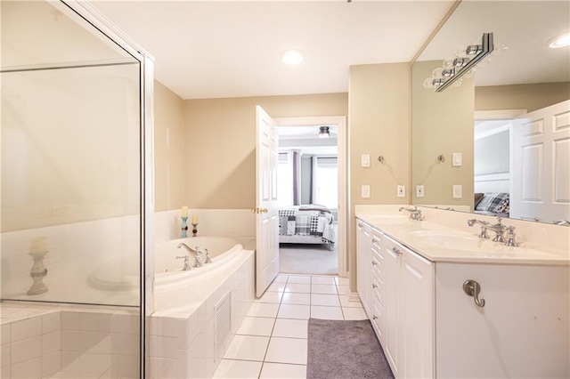 211 Colonial Homes Dr NW Unit 2501, Atlanta, GA 30309 - bathroom featuring connected bathroom, a garden tub, double vanity, and tile patterned flooring