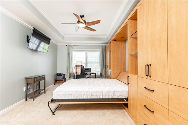 211 Colonial Homes Dr NW Unit 2501, Atlanta, GA 30309 - bedroom with ornamental molding, light carpet, a raised ceiling, ceiling fan, and baseboards