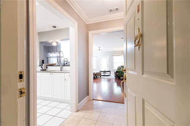 211 Colonial Homes Dr NW Unit 2501, Atlanta, GA 30309 - foyer entrance with crown molding, a ceiling fan, light tile patterned floors, and baseboards