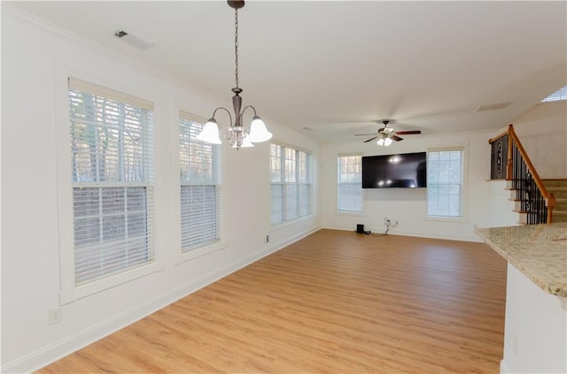 unfurnished living room featuring light wood-style flooring, baseboards, and stairs