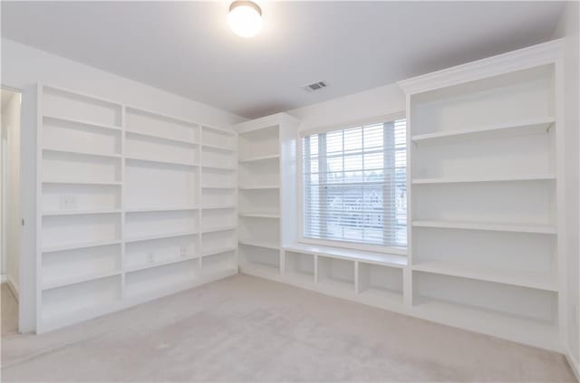 walk in closet with visible vents and carpet flooring