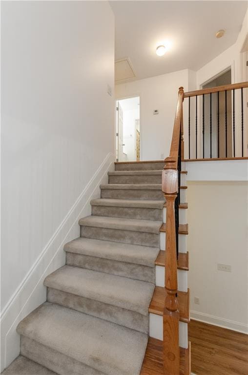 stairs featuring baseboards and wood finished floors