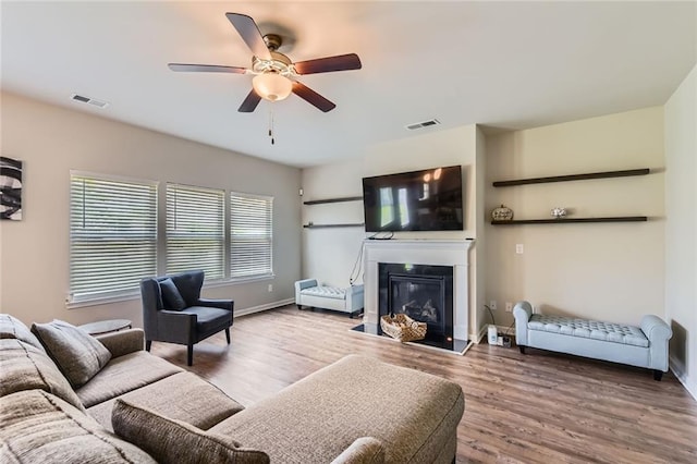 2486 Bear Mountain St, Lithonia, GA 30058 - living area featuring ceiling fan, wood finished floors, and a glass covered fireplace