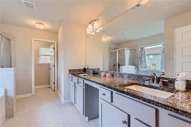 2486 Bear Mountain St, Lithonia, GA 30058 - bathroom featuring a shower stall, double vanity, plenty of natural light, and tile patterned floors