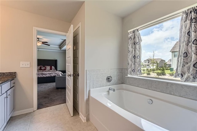 2486 Bear Mountain St, Lithonia, GA 30058 - ensuite bathroom featuring healthy amount of natural light, a garden tub, vanity, and tile patterned floors