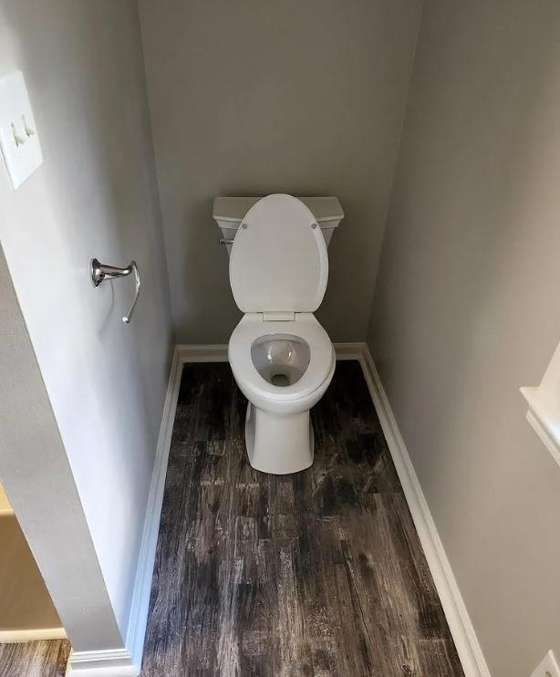 bathroom featuring toilet and hardwood / wood-style flooring