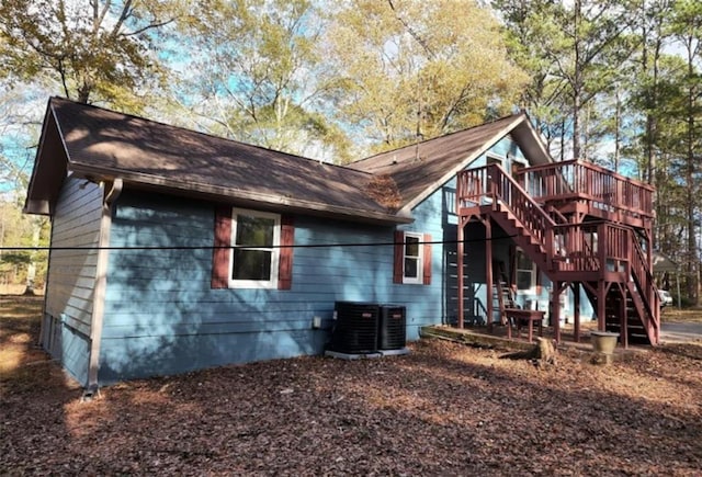 back of property featuring a wooden deck and central AC