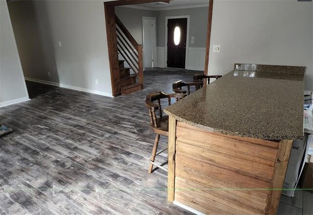 kitchen featuring crown molding and hardwood / wood-style flooring