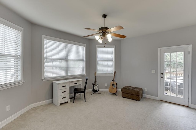 office featuring light carpet, a healthy amount of sunlight, and ceiling fan