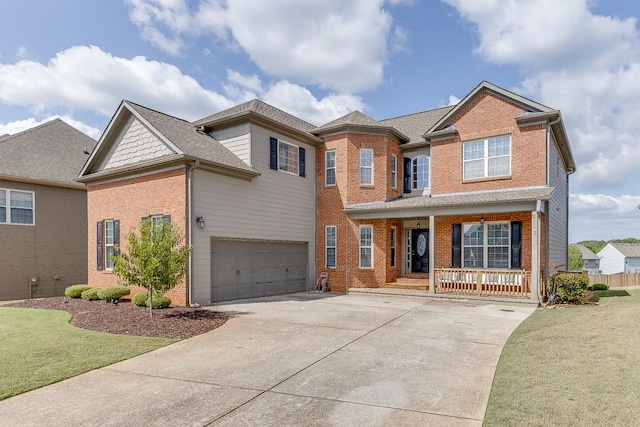 view of front of house featuring a front lawn, a garage, and covered porch