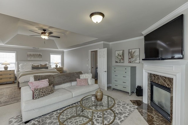 bedroom with ornamental molding, multiple windows, ceiling fan, and a fireplace