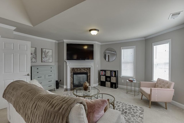 carpeted living room with ornamental molding, lofted ceiling, and a premium fireplace