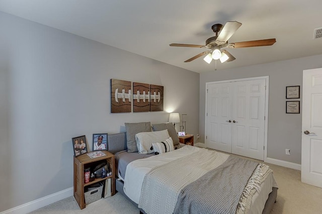 carpeted bedroom featuring ceiling fan and a closet