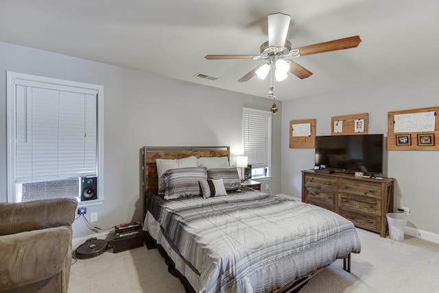 bedroom with ceiling fan and light colored carpet