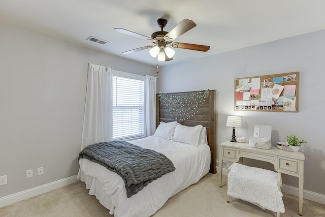 bedroom with ceiling fan and light carpet