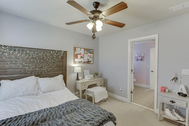 carpeted bedroom featuring ceiling fan and connected bathroom