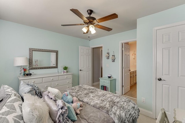 bedroom featuring ensuite bathroom, ceiling fan, and light colored carpet