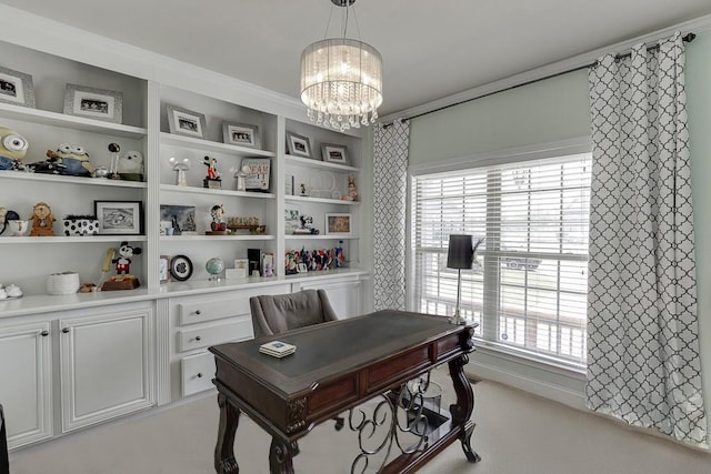 carpeted home office featuring an inviting chandelier and ornamental molding