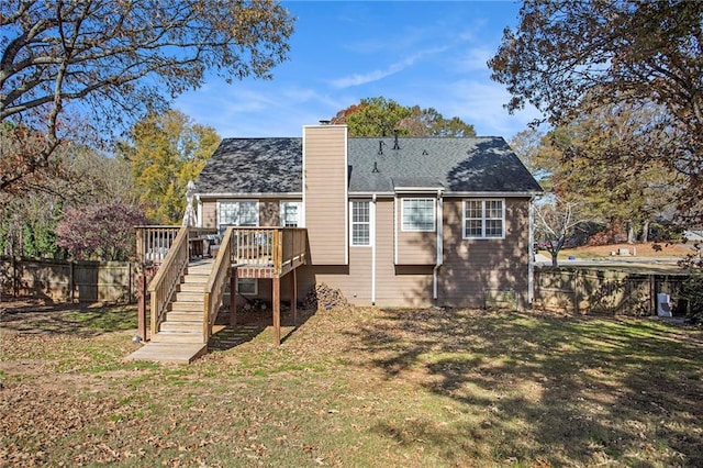 rear view of house with a yard and a wooden deck