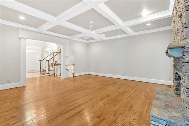 unfurnished living room featuring coffered ceiling, light wood-style floors, beam ceiling, baseboards, and ceiling fan
